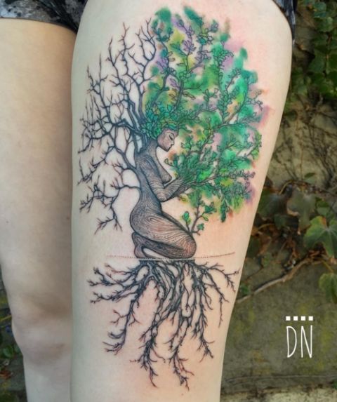 Another stunning Dino Nemec design, this tattoo features a tree figure kneeling as a blend of ivy, jade and pear colors make up its