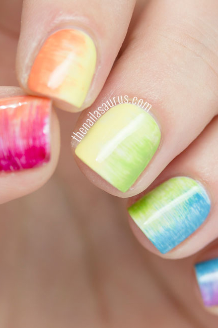 You'll need a super-skinny, flat nail art brush to achieve this rainbow blur — moving the brush horizontally across the nail pushes two nail polish hues into each other, blending them seamlessly.
See more at The Nailasaurus »