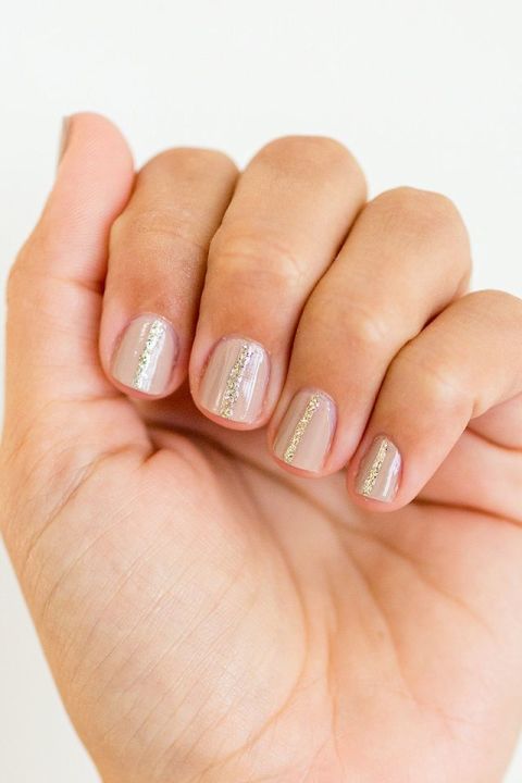 Want a simple way to upgrade your favorite Essie "Topless and Barefoot" nude? Draw a skinny line of gold glitter down the center of each nail and watch how pretty the metallic looks glinting in the summer sun.
See more at Lauren Conrad »