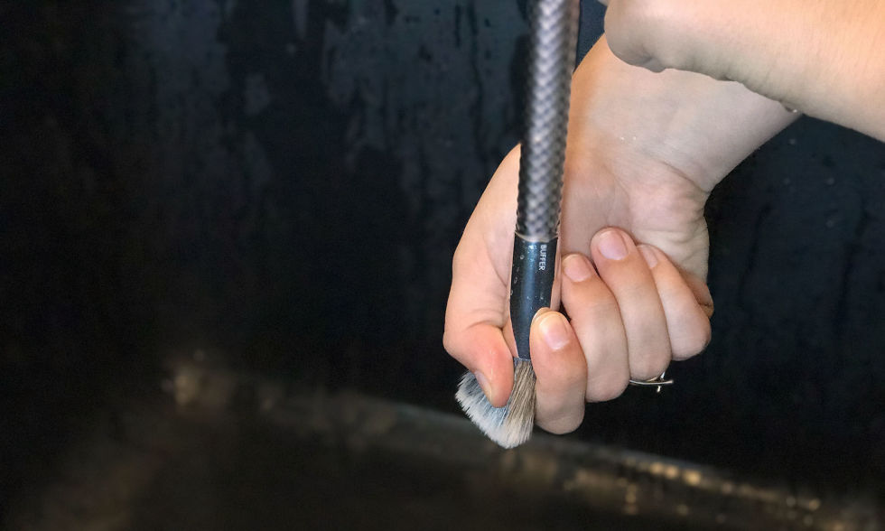 Gently press on the bristles with your fingers to release excess water. Don't tug too hard!
