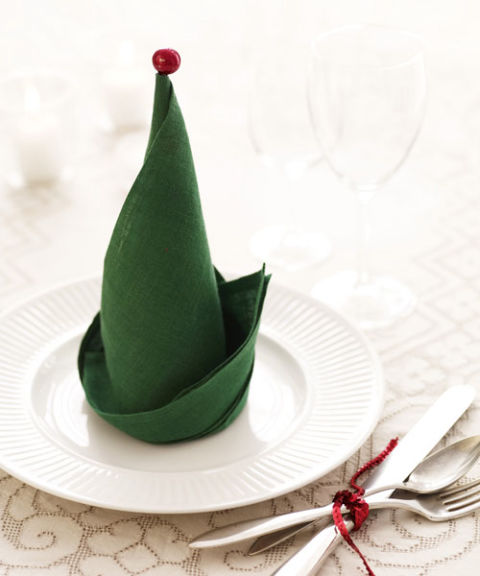 You might not have elves on call to set the table, but you can honor December's employees of the month by turning napkins into Santa's helpers' hats. To do: Gather square napkins that are on the stiff side (too thin or soft, and the folds won't hold). Once you've formed the hats, accessorize with mini-ornaments or jingle bells: Stick an ornament's hanger, or a bell looped onto a short piece of craft wire, into each hat's point. Place at holiday dinner guests' plates, and get ready to make merry.
