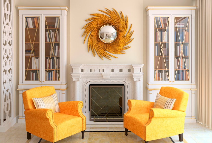 A pair of sunny yellow chairs doubles-down on the striking impact of a shining sunburst mirror. 