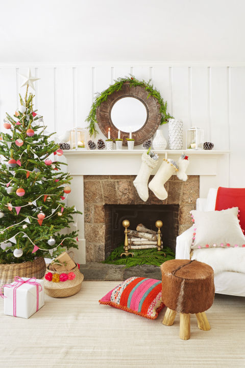 Warm up an out-of-use fireplace with a pile of birch logs and a few sprigs of greens. 