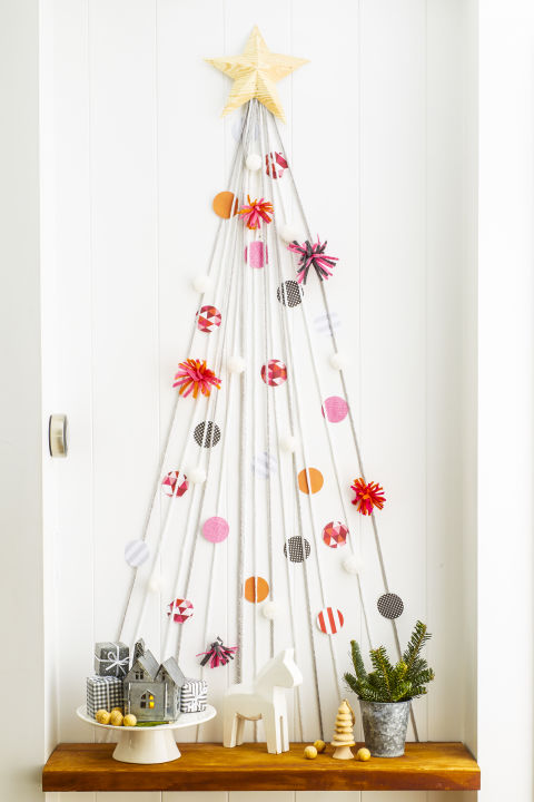 Use yarn to style a mini version on an empty wall or in a hallway. Enlist the kids to dress it to the nines with paper-circle "ornaments" and felt, attached with tape. 