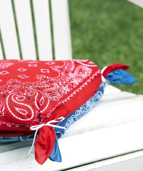 Soften outdoor chairs with no-sew pillow covers crafted from contrasting bandannas. Sandwich one cushion between two scarves, then join each corner together with a rubber band and hide bands with thin ribbon, as shown. 